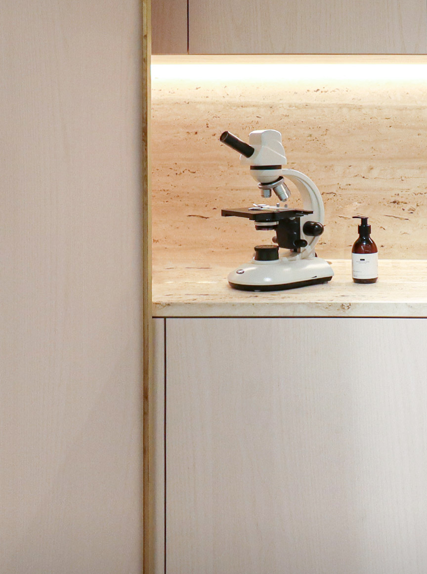 Ricardo Vila Nova Hair Doctors Clinic, Table with microscope and bottles on top